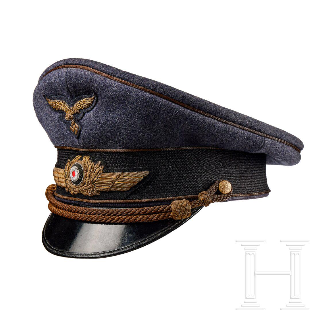 A Visor Cap for Generals: A Visor Cap for GeneralsCap body in blue-grey doeskin cloth, black mohair centre band, gilt-wire piping and chin cords retained by gilt finished pebbled buttons. Gilt-wire embroidered eagle and wreath