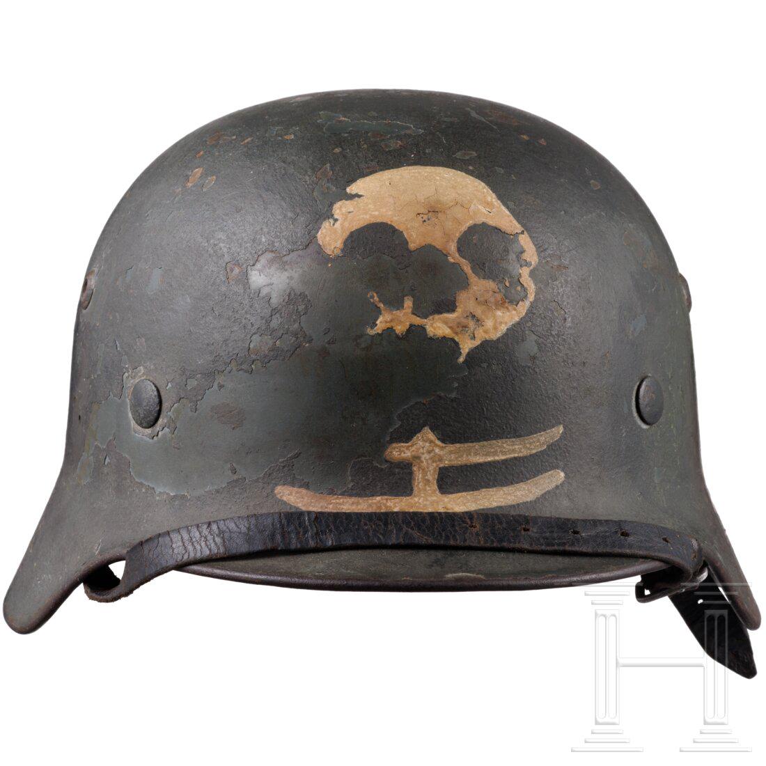 A Finnish army helmet, circa 1940: A Finnish army helmet, circa 1940 Deutscher Helm M 35 mit eingesetzten BelÃ¼ftungsnieten, mit feldgrauem Raulack Ã¼berstrichen, vs. ein zu Ã¼ber 50 % erhaltener ausgemalter weiÃŸer Totenkopf u