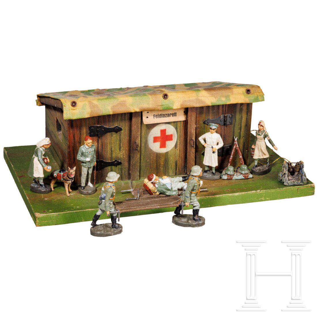 A Hausser-Elastolin Field-Hospital Bunker 13472/15 with medical figures and camp fire: A Hausser-Elastolin Field-Hospital Bunker 13472/15 with medical figures and camp fireHausser-Elastolin, Holz-MasseausfÃ¼hrung, 30er Jahre, 7 cm-Serie. Ein seltener Feldlazarett-Unterstand 13472/15, 