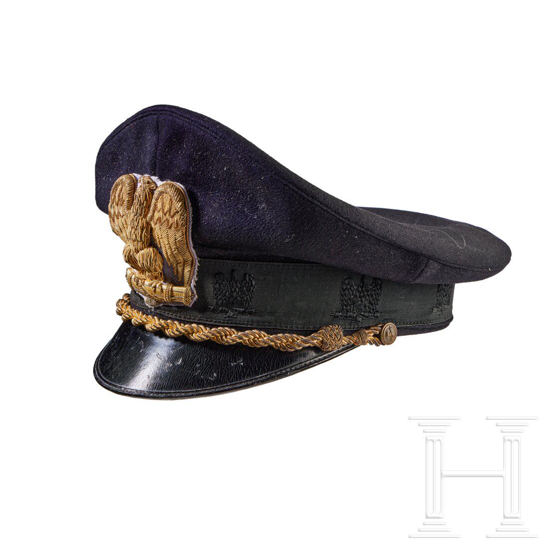A Visor Cap for Italian Ministerial Official: A Visor Cap for Italian Ministerial OfficialCap body in navy-blue wool, black ribbed rayon centre band with machine-embroidered eagle and fasces motif, black piping, gilt wire braided chin cord retain