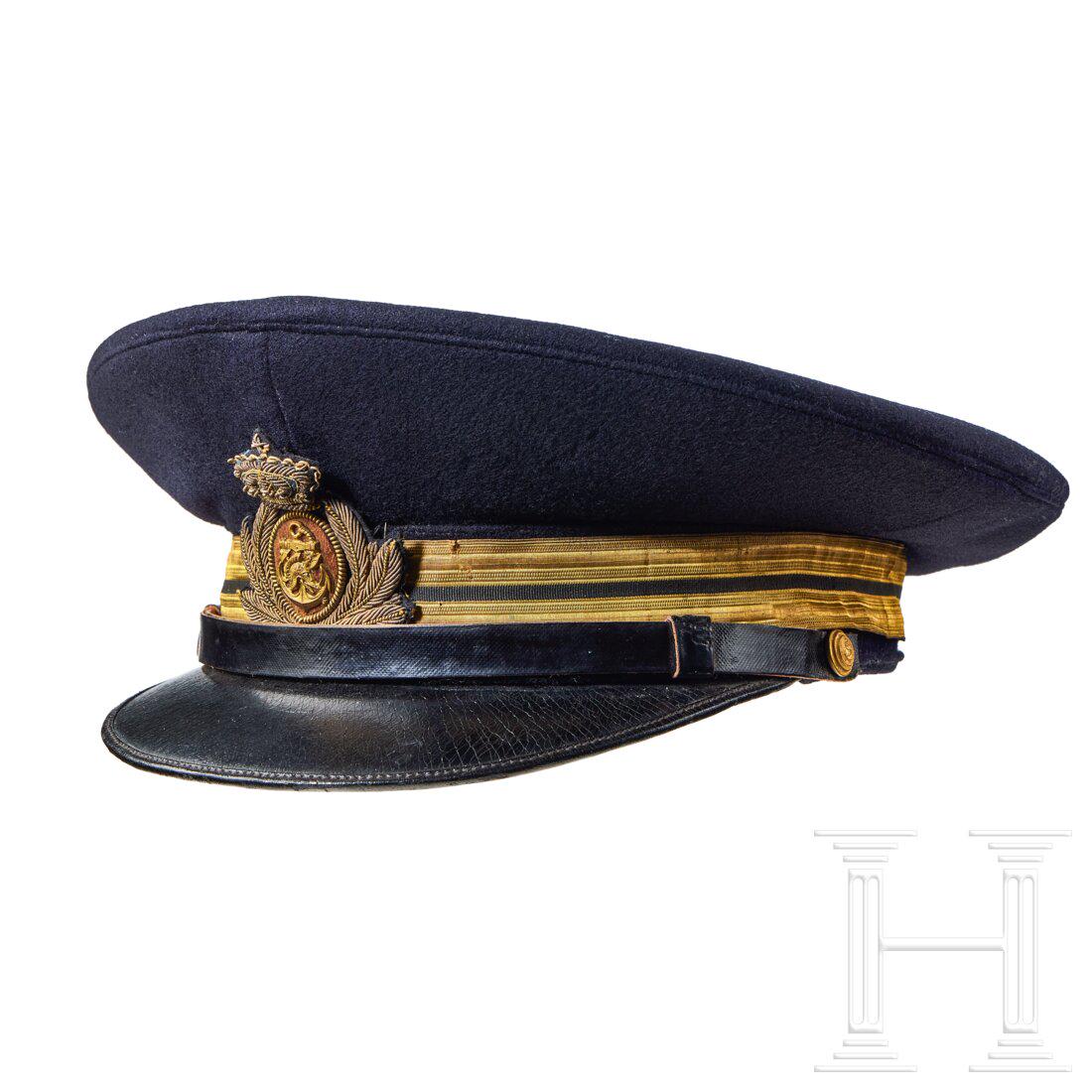 A Visor Cap for Italian Navy Ensign: A Visor Cap for Italian Navy EnsignCap body in navy-blue wool, gilt metallic fabric centre band with single black stripe, dark-blue wool piping, black leather chinstrap retained by gilt finish buttons