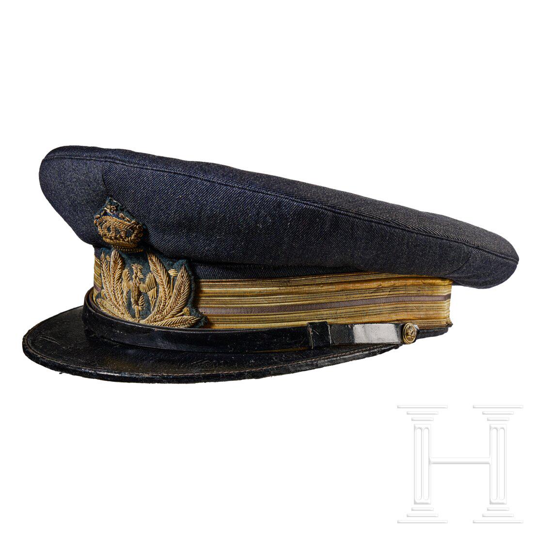 A Visor Cap for Italian Air Force Lieutenant: A Visor Cap for Italian Air Force LieutenantCap body in blue-grey wool, gilt metallic fabric centre band with single grey stripe, blue-grey wool piping, black leather chinstrap retained by gilt finish