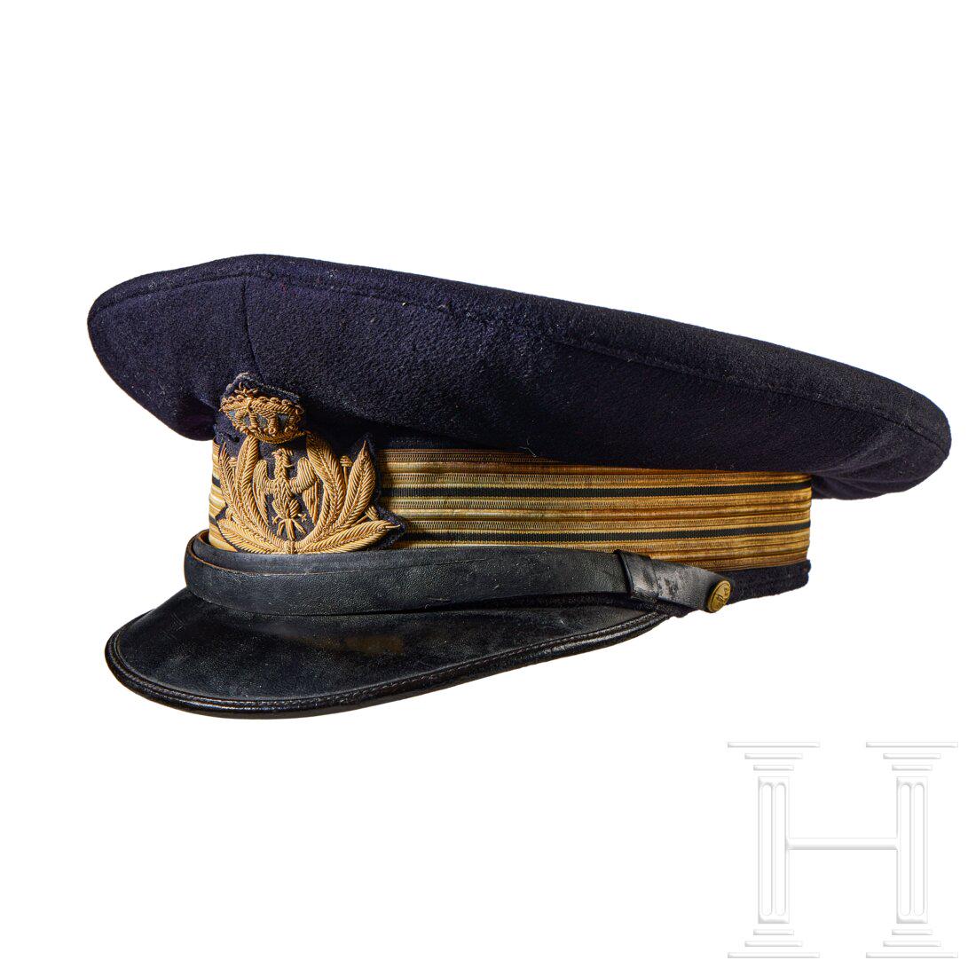 A Visor Cap for Italian Navy Pilot Lieutenant: A Visor Cap for Italian Navy Pilot Lieutenant Cap body in navy-blue wool, gilt metallic fabric centre band with double black stripe, dark-blue wool piping, black leather chinstrap retained by gilt fin