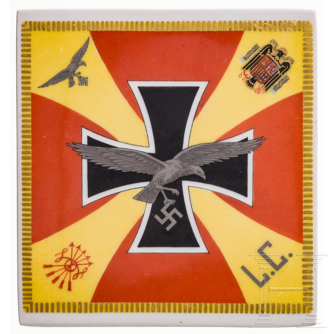 A tile with the standard of the Condor Legion, made by the Porcelain Manufactory KPM: A tile with the standard of the Condor Legion, made by the Porcelain Manufactory KPMViereckige Porzellanfliese mit vorderseitiger glasierter, farbiger Darstellung der Standarte mit goldenen/silbernen