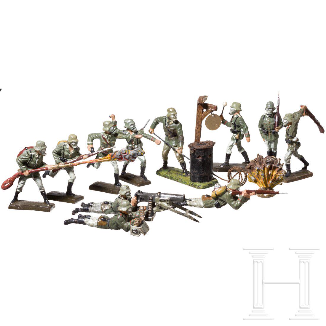 Eleven Lineol soldiers of the German Army with gas mask and an Elastolin shell impact: Eleven Lineol soldiers of the German Army with gas mask and an Elastolin shell impactLineol, MasseausfÃ¼hrung, 30er Jahre, 7 cm-Serie. Elf Soldaten des Heeres mit Gasmaske, dabei verschiedene kÃ¤m
