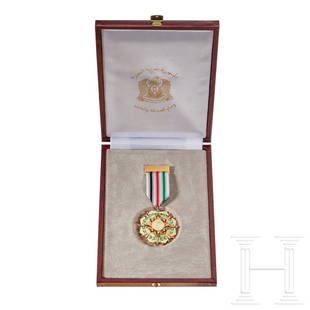 A Syrian Order of Friendship and Cooperation: A Syrian Order of Friendship and CooperationGilt finish, multi-piece construction, cream enameled base of an eight-pointed star with green enamel laurel wreath and four pennant-shaped Syrian flags of