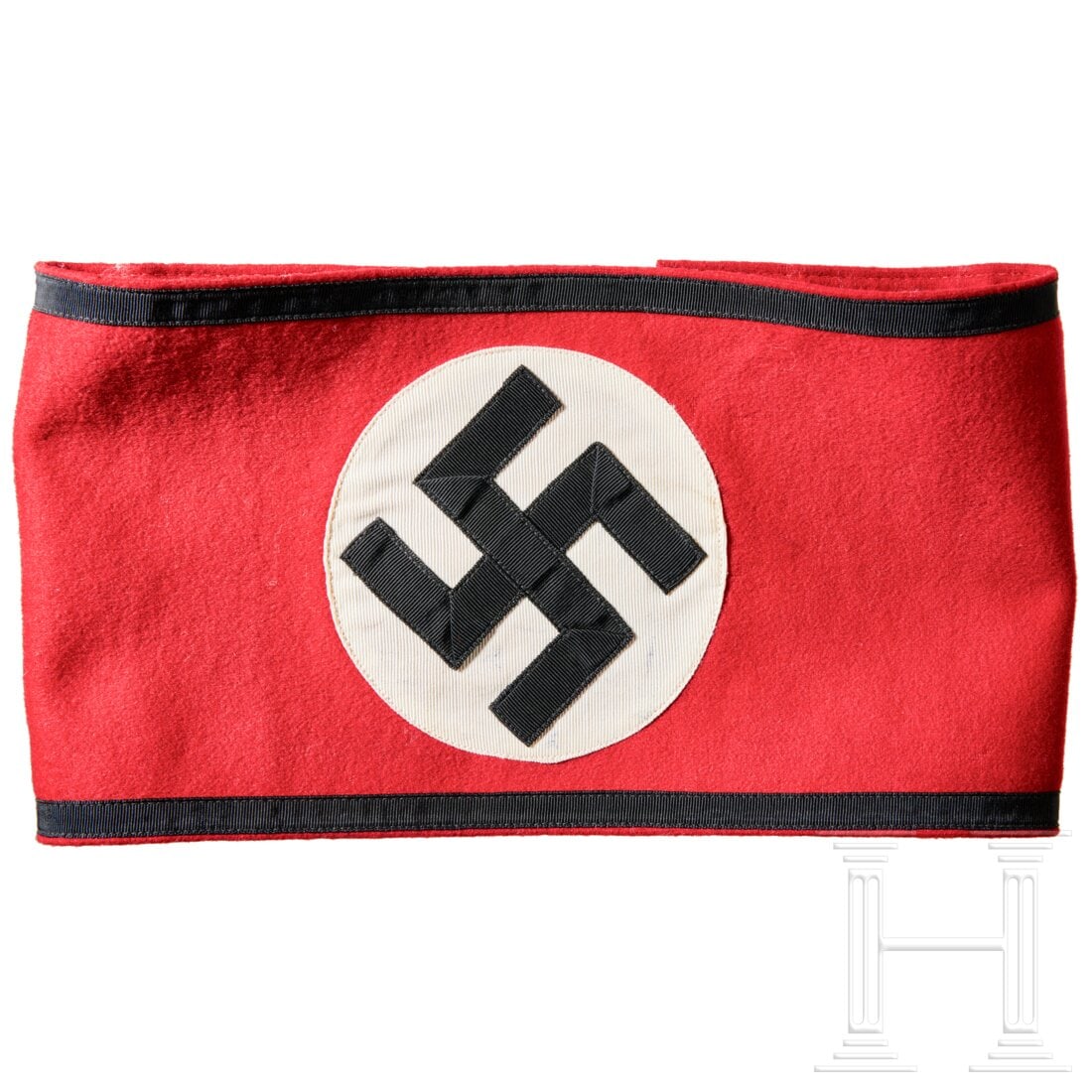 An Allgemeine SS Armband: An Allgemeine SS ArmbandRed wool cloth band, at centre separately machine-applied white ribbed rayon circle with multi-piece canted black swastika, black ribbed tape border at top and bottom. Reverse 