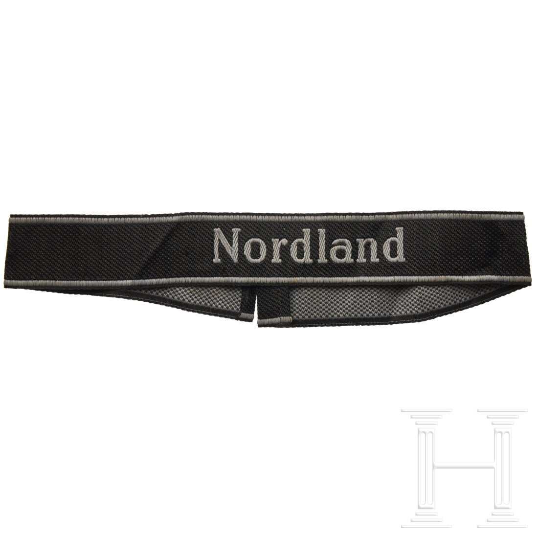 A cuff title â€Nordlandâ€œ for members of the 11. SS-Panzer-Grenadier Division: A cuff title ”Nordlandâ€œ for members of the 11. SS-Panzer-Grenadier DivisionBlack band in BeVo design with silver-grey woven name in Latin script, bordered along top and bottom edges with i