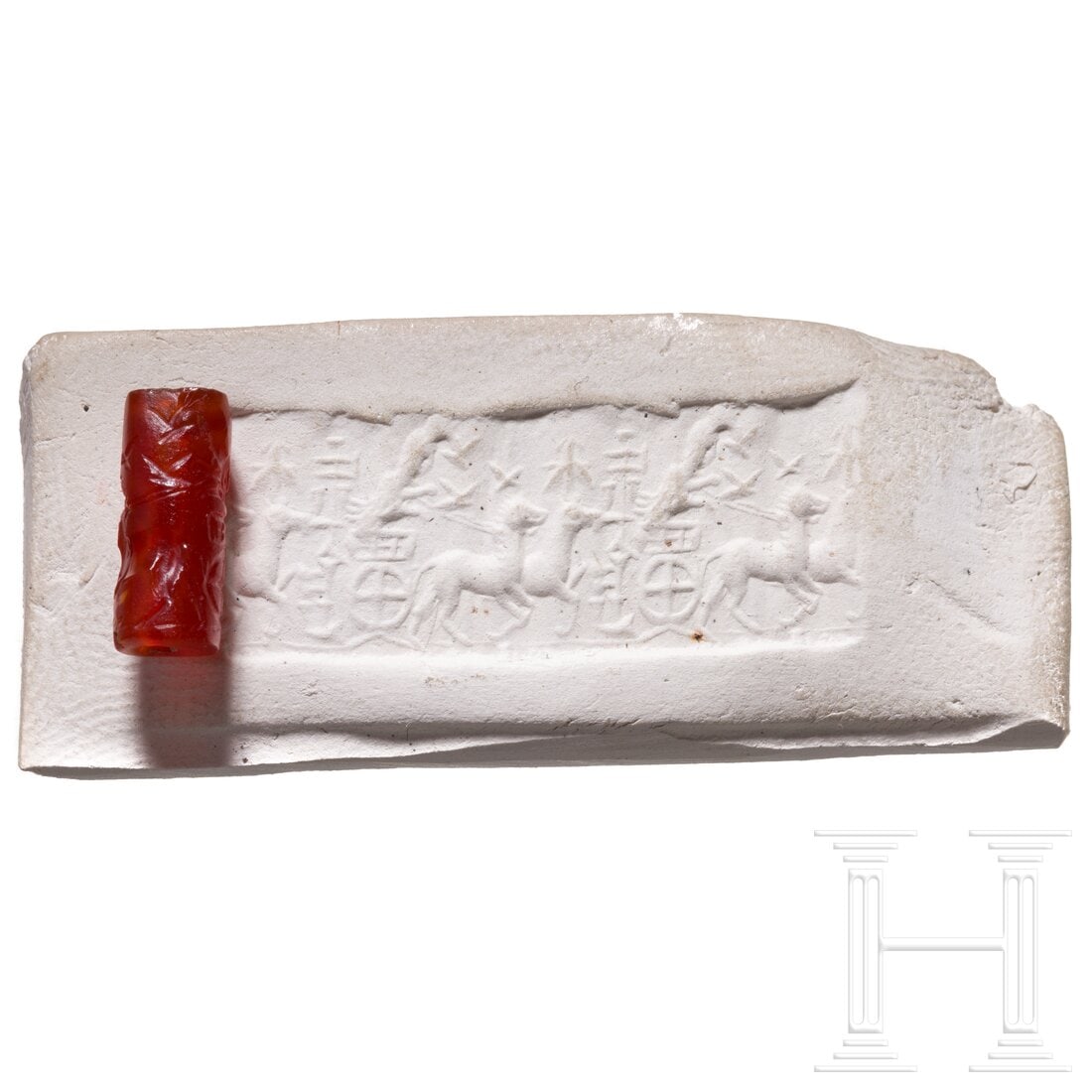 A Neo-Assyrian agate cylinder seal with chariot depiction, 8th century B.C.: A Neo-Assyrian agate cylinder seal with chariot depiction, 8th century B.C.12 mm long and 5 mm wide roll seal made of red agate and of high quality. On the left of the impression a vertical column wit