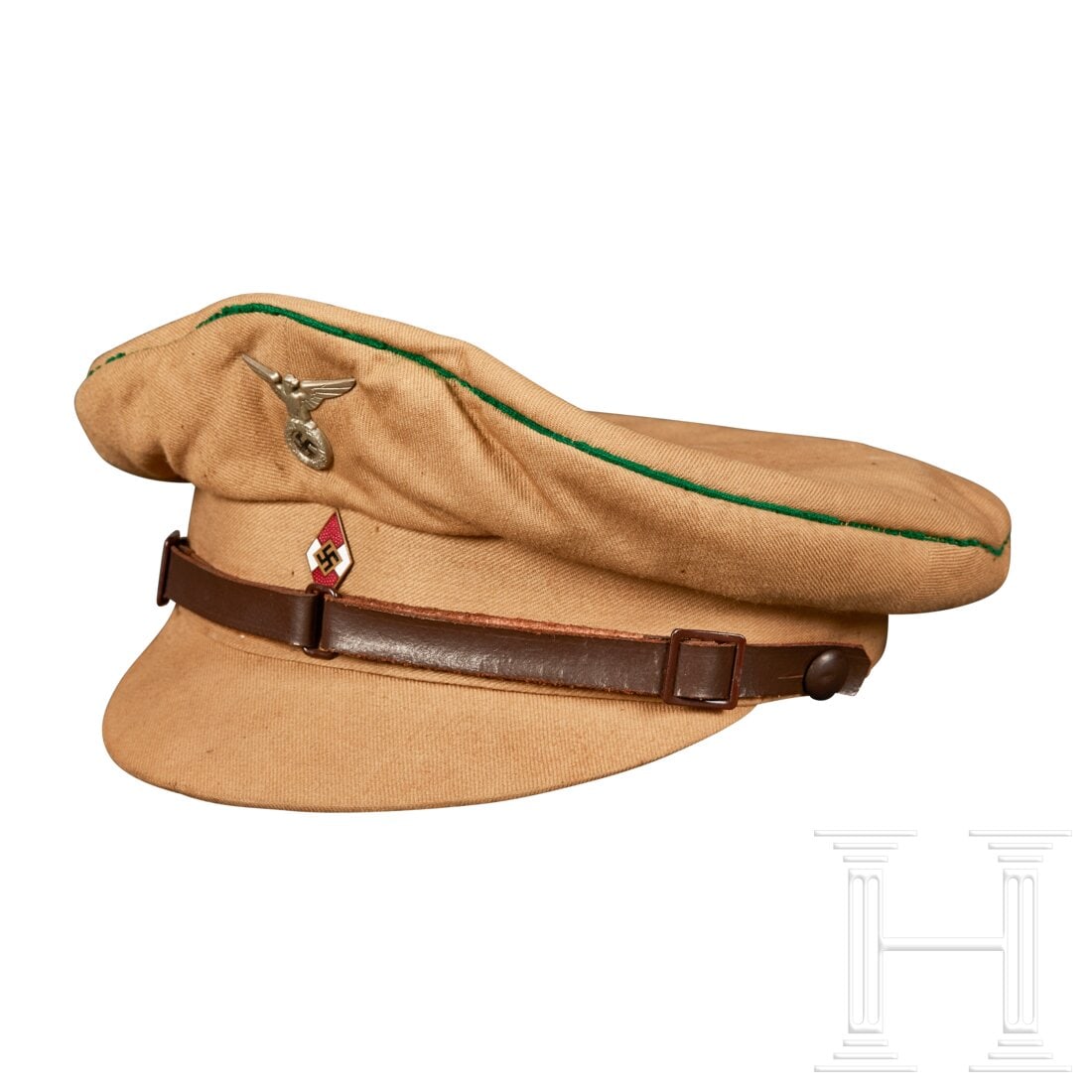 A 1934 Service Cap for Hitler Youth: A 1934 Service Cap for Hitler YouthCap body in khaki-brown tricot cloth, khaki-brown centre band, green piping around crown, nickel silver first type eagle, enameled youth badge with swastika centered