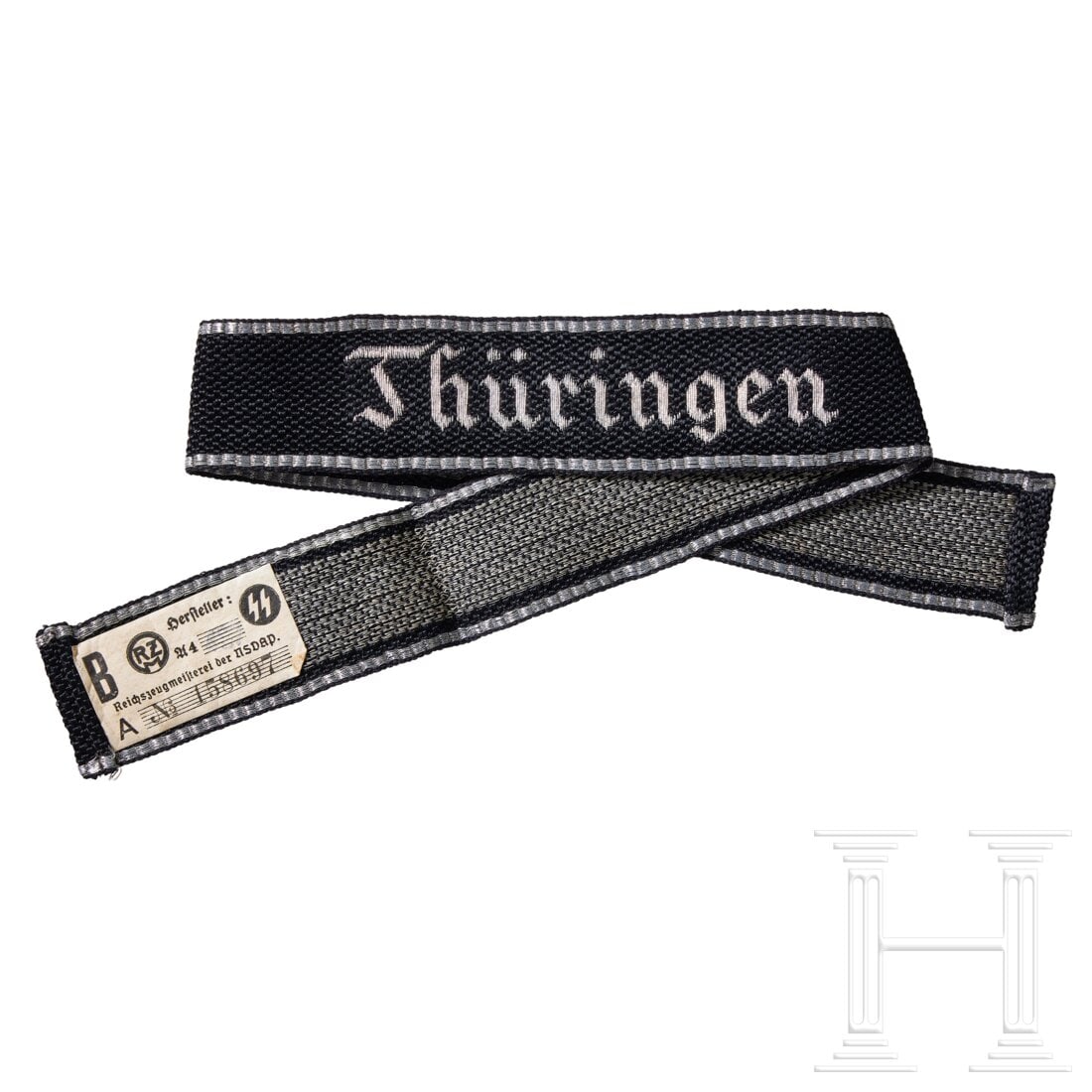 A cuff title “Thüringen?? for officers: A cuff title “Thüringen” for officersWoven black rayon band with machine woven embroidered script, in bright silver/aluminum threads. Bordered at both top and bottom edges in horizontally wov