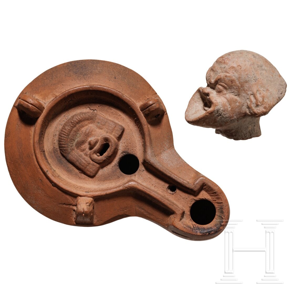 A Hellenistic terracotta head depicting an actor of the New Comedy, 3rd - 1st century B.C., plus an (1 of 2)