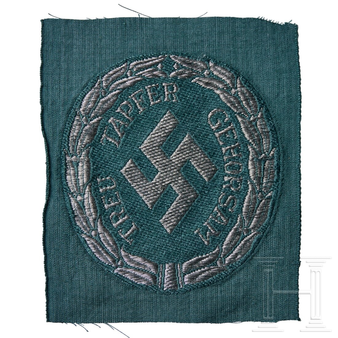 A Sleeve Shield for Schutzmannschaft (Schuma) Officer: A Sleeve Shield for Schutzmannschaft (Schuma) Officer Grey-green cloth backing, silver-aluminum machine-woven swastika within wreath and motto "TREU TAPFER GEHORSAM". USA lot - more info hereCondition
