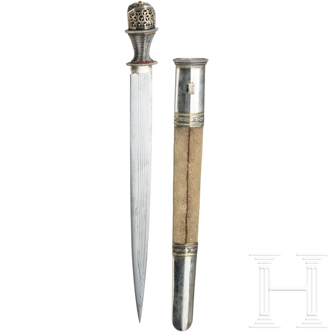 A silver-mounted Tibetan lothi, circa 1900: A silver-mounted Tibetan lothi, circa 1900Beidseitig mehrfach fein gekehlte Klinge mit im Rücken liegender Spitze. Der eingezogene Griff mit feiner Drahtwicklung und teilvergoldeter Knaufkappe aus Si