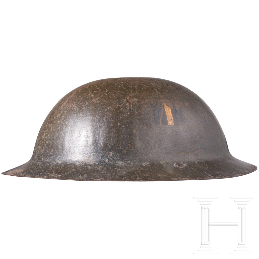 A steel helmet "Brodie": A steel helmet "Brodie" Frühe Fertigung, die einteilige Glocke ohne Randeinfassung und im Scheitel vernieteten ledernen Kinnriemen an versplinteten Haltebügeln, das Futter mit schwarzem Ersatzmateri