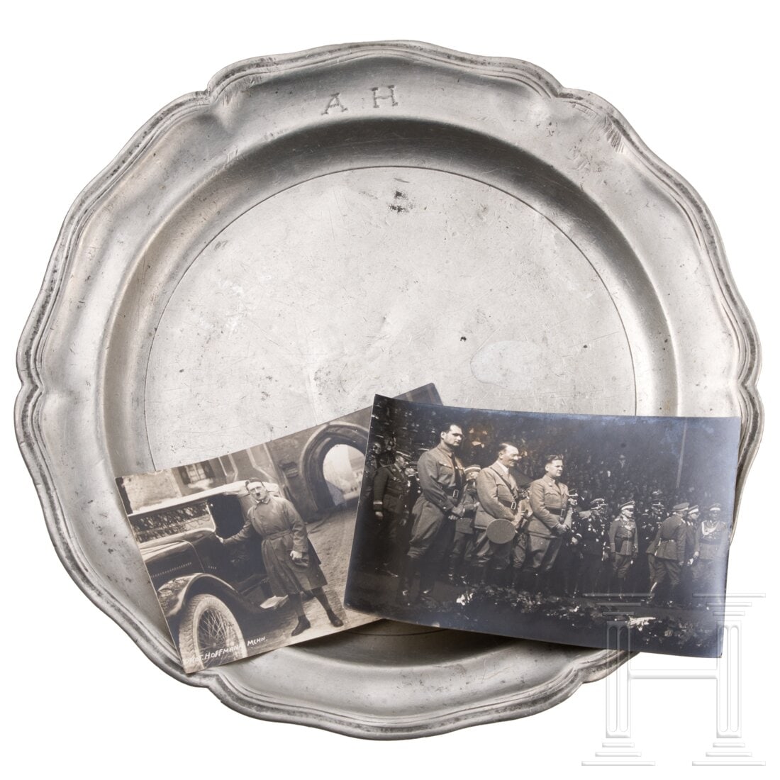 Adolf Hitler - a dinner plate from Landsberg prison with seven photos, estate of Rudolf Hess: Adolf Hitler - a dinner plate from Landsberg prison with seven photos, estate of Rudolf HessA heavy pewter plate, bearing the initials "A.H." on the front, the reverse engraved with "Wolf Andreas Hess