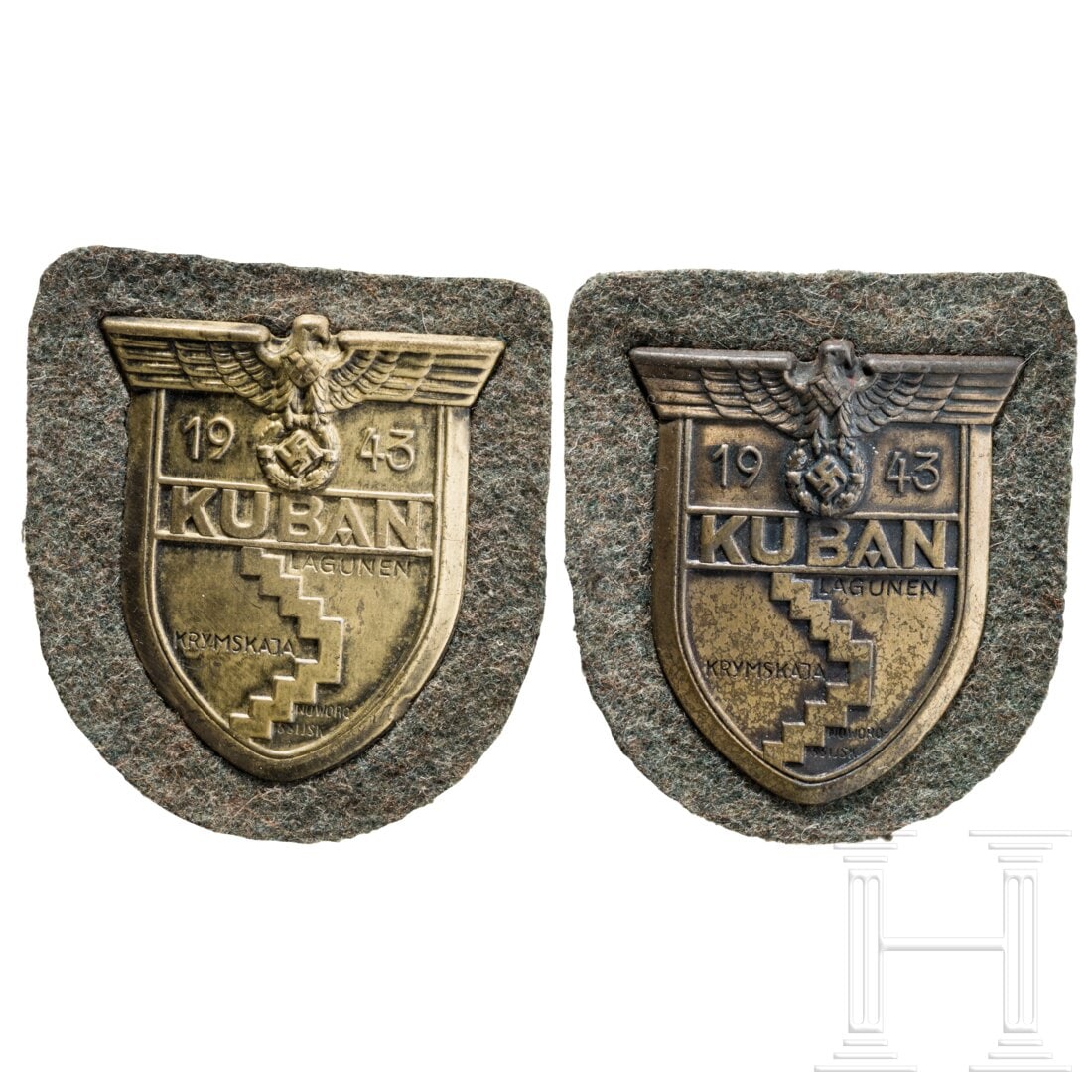 Two Kuban Shields, manufacturer Rudolf Karneth: Two Kuban Shields, manufacturer Rudolf KarnethEisen bronziert auf feldgrauer Tuchunterlage, komplett mit Rückenplatte und Papierabdeckung. Typische Fertigung der Fa. Rudolf Karneth.Condition: II