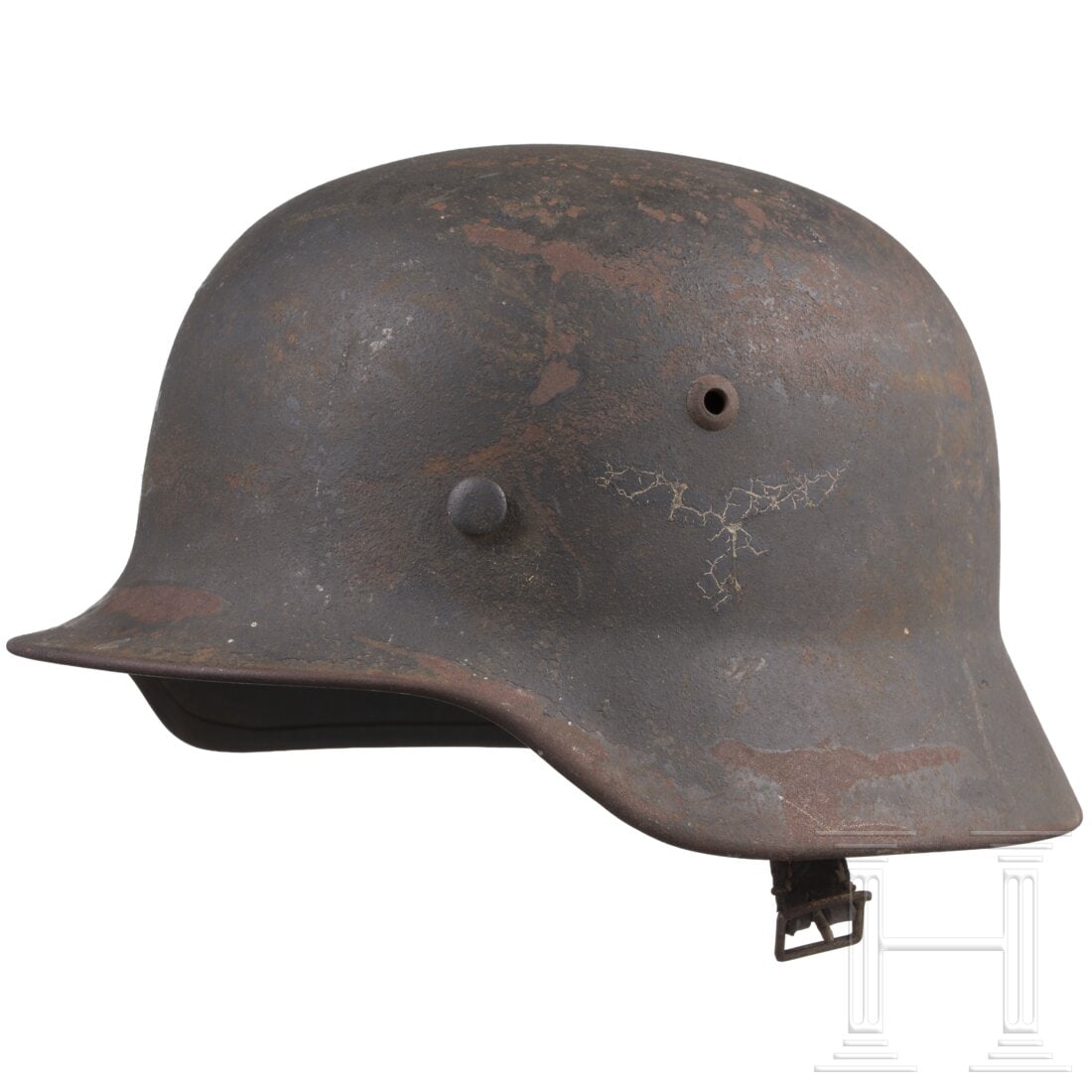 A Luftwaffe M35 steel helmet with remnants of the two decals: A Luftwaffe M35 steel helmet with remnants of the two decalsThe shell with inset ventilation rivets and Luftwaffe blue paint. Heavily surface-rusted, the emblems faintly visible, and the internal stam