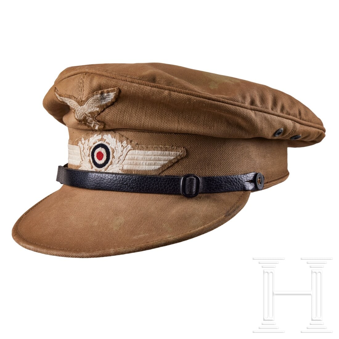 A Tropical Visored Field Cap “Hermann Mayer?? for Luftwaffe Personnel: A Tropical Visored Field Cap “Hermann Mayer” for Luftwaffe PersonnelKhaki-brown cotton body and visor exhibits moderate staining. Four metal grommets, black leather chinstrap with metal buckle