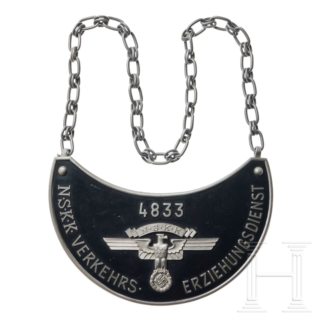 A NSKK Gorget "Verkehrs-Erziehungsdienst": A NSKK Gorget "Verkehrs-Erziehungsdienst"Black finish shield, at center silver finish NSKK eagle with spread wings, above “4833” in silver finish, below “N.S.K.K. VERKEHRS- ERZIEHUNGSDIENST&