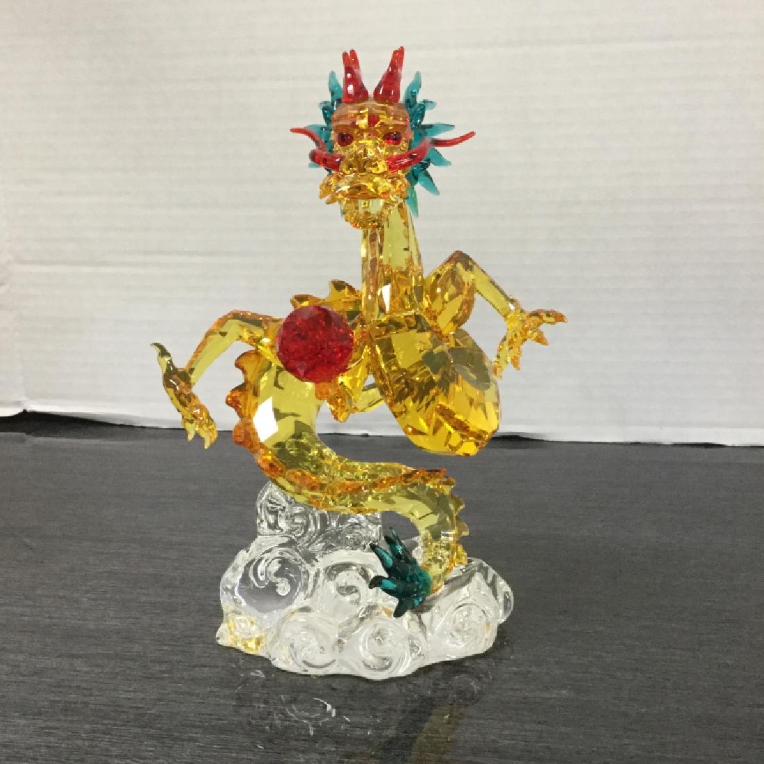 Swarovski Tutelary Spirit Auspicious Dragon: An Asian-inspired design with an imperial symbolic meaning, this dragon sparkles in Light Siam, Blue Zircon, and a rich variety of other crystal colors on a clear crystal base. The creation comes with