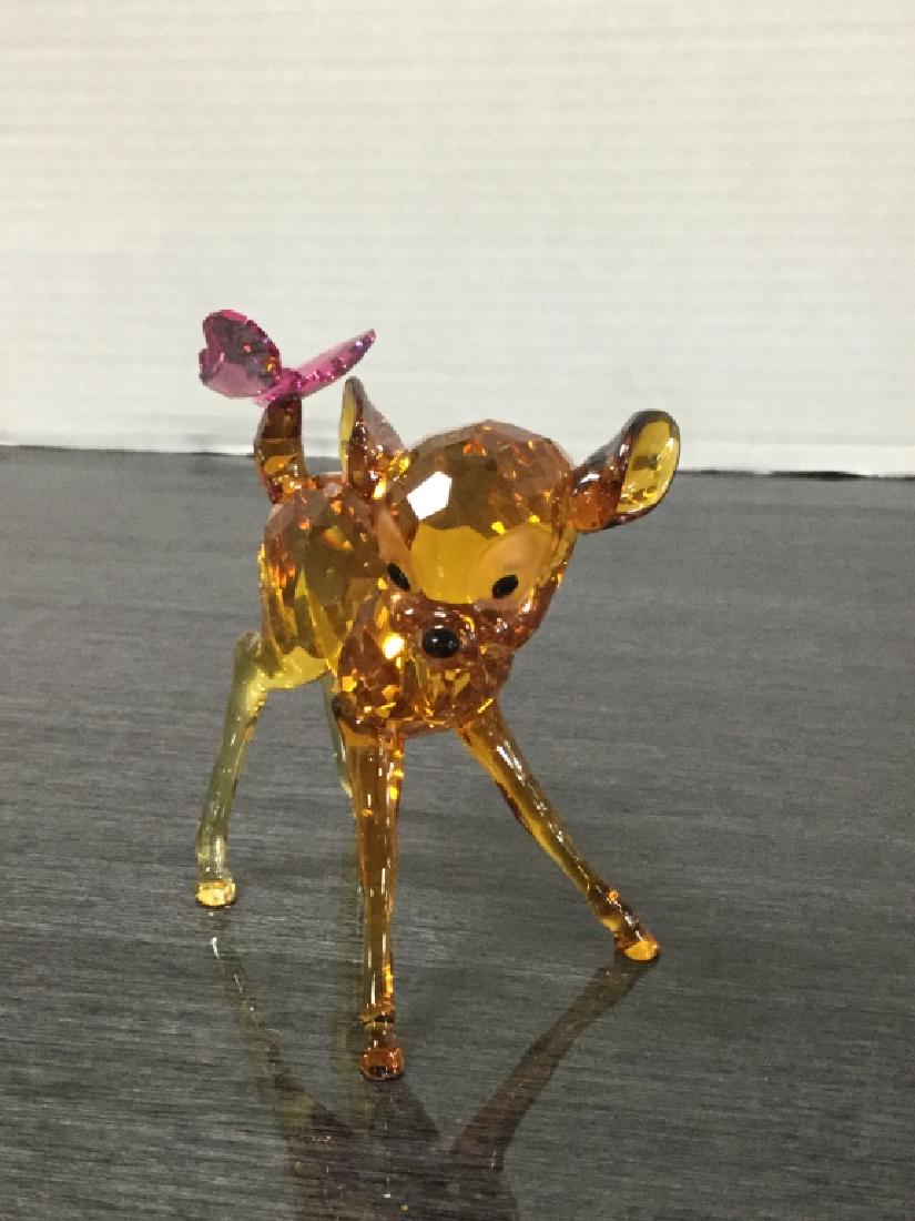 Swarovski 2013 Disney Bambi Retired: This full color, retired figurine is number 5004688. With his Topaz crystal body with Silver Shade coating and a cute butterfly in Rose crystal on his tail, Bambi brings joy to Disney fans and collect
