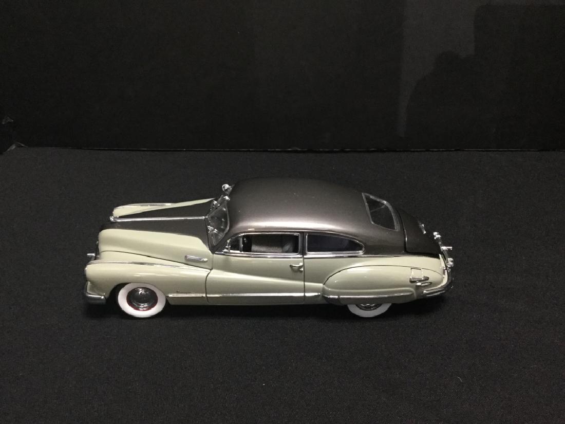 Danbury Mint 1948 Buick Roadmaster Coupe: Buick had the future clearly in sight when they produced the '48 Roadmaster. This classic car was fighter plane-inspired featuring "Sweeping Airfoil" fenders and an unmistakable "gun sight" hood ornam