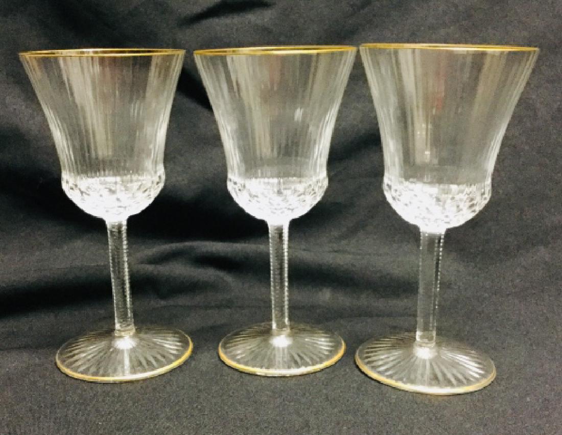 3 SAINT LOUIS "APOLLO GOLD" WATER GOBLETS: Crystal wine glasses rimmed in 24kt gold. Approximately 7.5" tall. Hand wash. Made in France. About Saint Louis Crystal: Made exclusively in France since 1586, Saint Louis crystal vibrates with the im