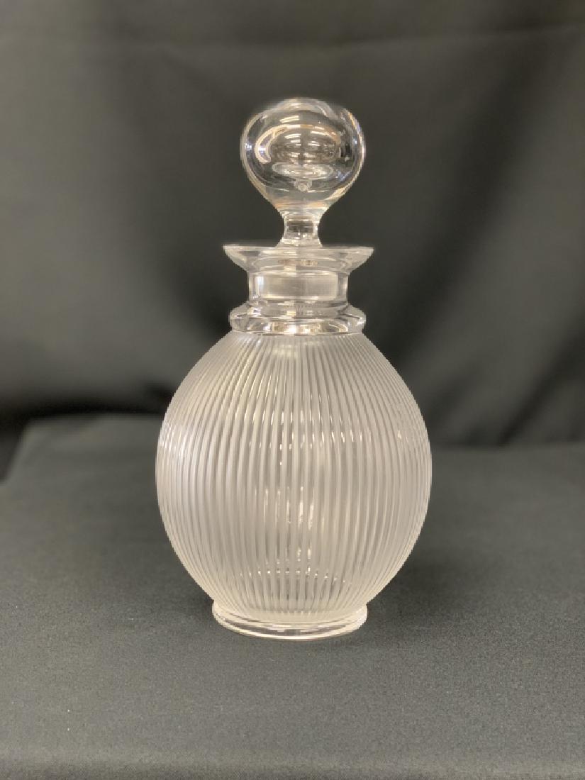 LALIQUE "LANGEAIS" WINE DECANTER: Designed in 1976 by René’s son Marc Lalique, this pattern has become iconic. Referencing both fluted antique columns and modernist architecture, it takes seven glass masters to create this decanter