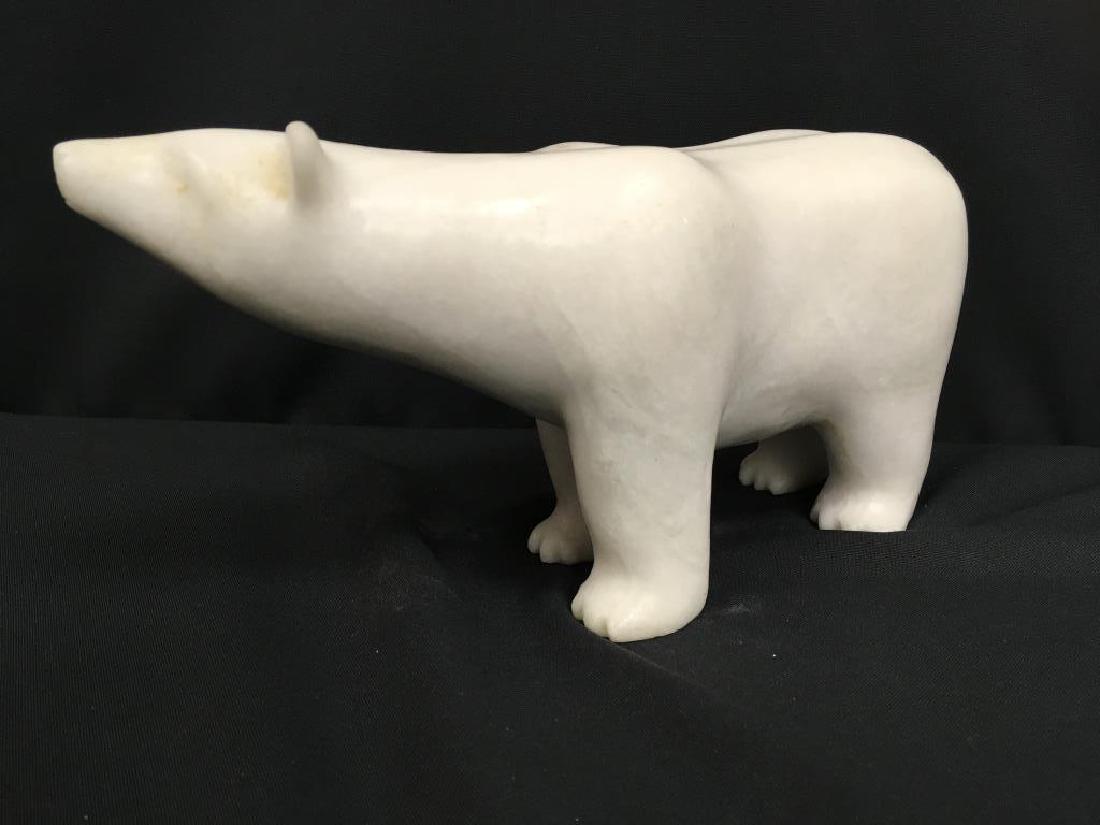 CARVED ALABASTER POLAR BEAR FIGURINE: Alabaster standing polar bear figurine. Hand-carved, this bear stands still with head raised slightly to smell the salt-fresh air. Mint condition.Approximate Measurements: 11"L x 3.5"W x 5.5"H