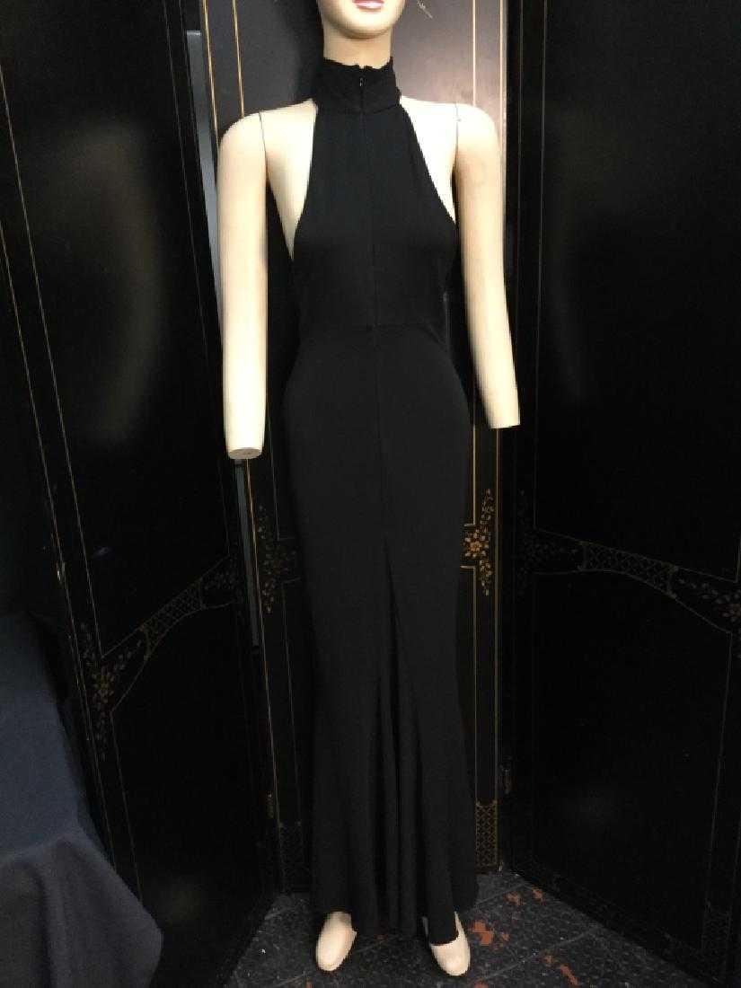 MICHAEL KORS BLACK SLINKY HALTER BARE EVE GOWN 2: Black slinky rayon spandex material. Back baring with a mock tneck halter that zips in front for a collar effect. Daring sides on the bust top, slim fitting beautiful detail for the skirting. Size 2 l