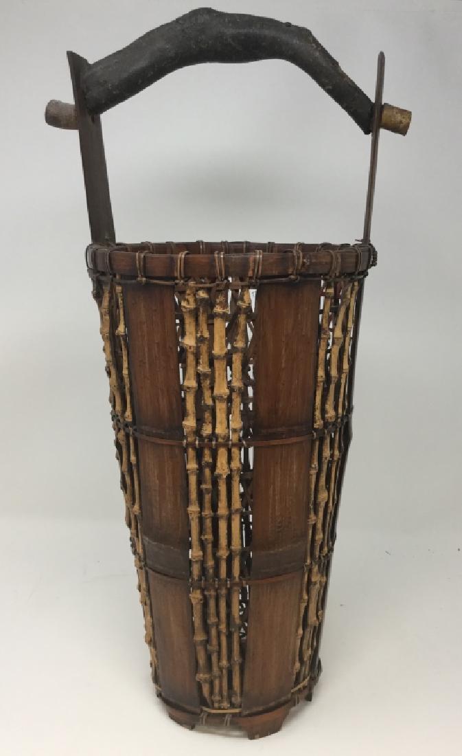 ANTIQUE JAPANESE UNUSUAL IKEBANA BAMBOO BASKET: 20.5" x 5.5"This example dates to the turn of the 20th century, all bamboo plus possibly birch handle. property of a Palm Beach collector. Third party shipping required