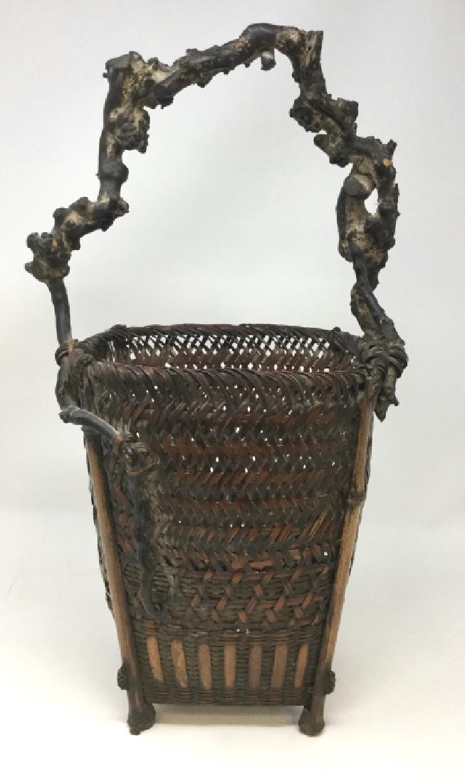 ANTIQUE JAPANES IKABENA HAND WOVEN FLOWER BASKET: 17.5" x 4.5" Dates to the mid 19th century, tight woven smoked bamboo, with birch tree branch handle, note one side support is loose, otherwise very good condition property of a palm beach collector. 
