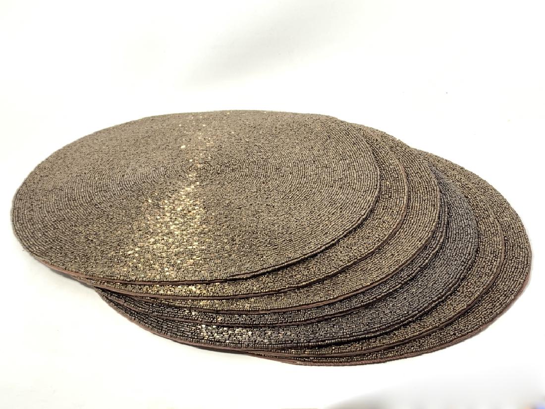 SET OF (7) NEVER USED KIM SYBERT PLACE MATS: Each one is of antique gold beads. They measure 14" in diamete. What a classy way to decorate your table for the holidays. Still with original price tags of $75 each. Third party shipping required
