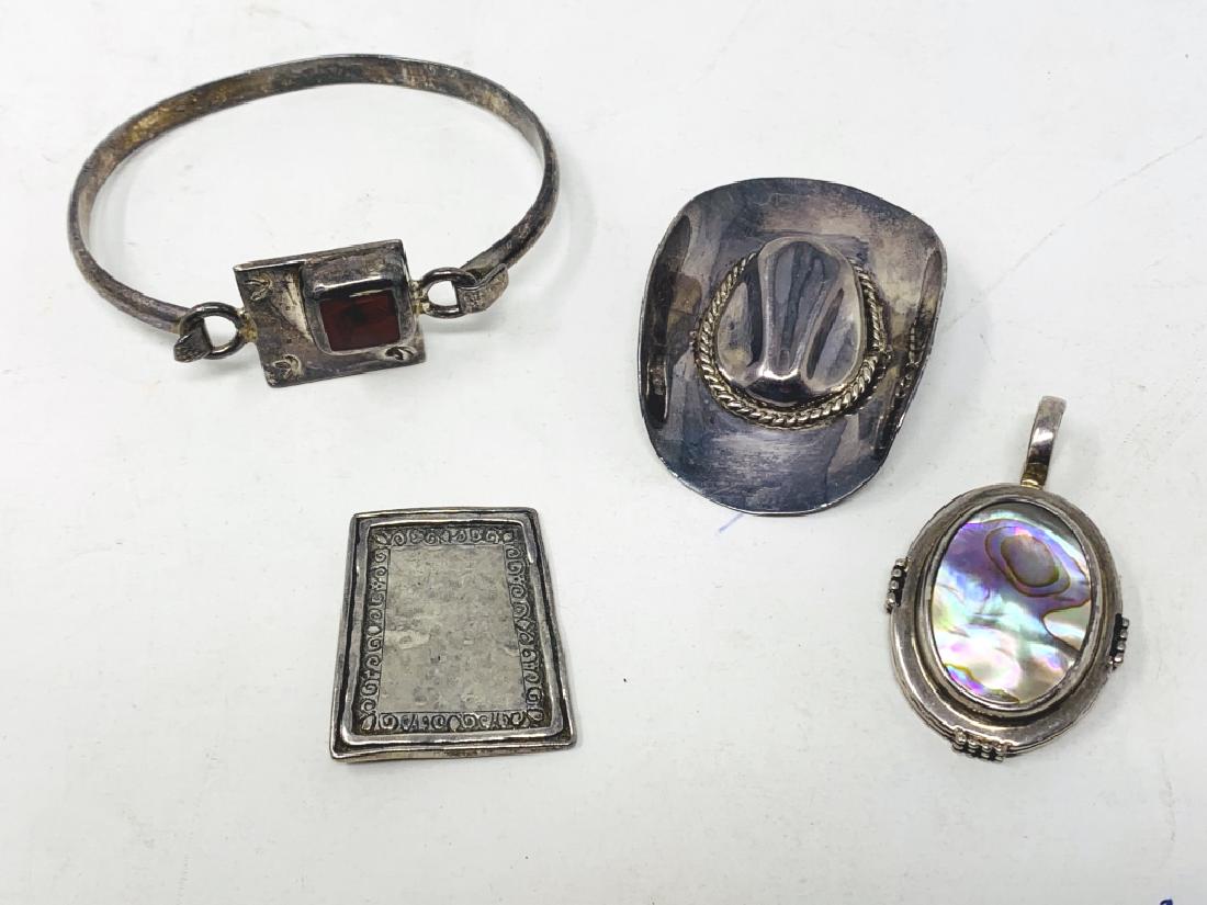 LOT OF VINTAGE STERLING SILVER JEWELRY: To include; Sterling Mexican hat pin,Sterling Mexican bracelet, Sterling Mexican pendant , and Sterling pendant with abalone. Total weight 58 grams 3rd party shipping required