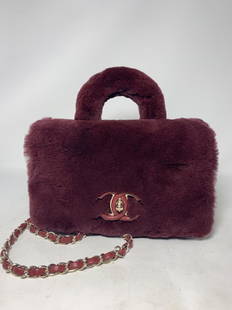 CHANEL FUR & LEATHER FLAP BAG TOP HANDLE W/ STRAP: CHANEL FUR & LEATHER FLAP BAG New Condition with Authenticity card. Fur over calfskln leather, CC logo on front with front latch. Measures 9"H x 9"W Inside it has 2 compartments and a 6" zippered pock