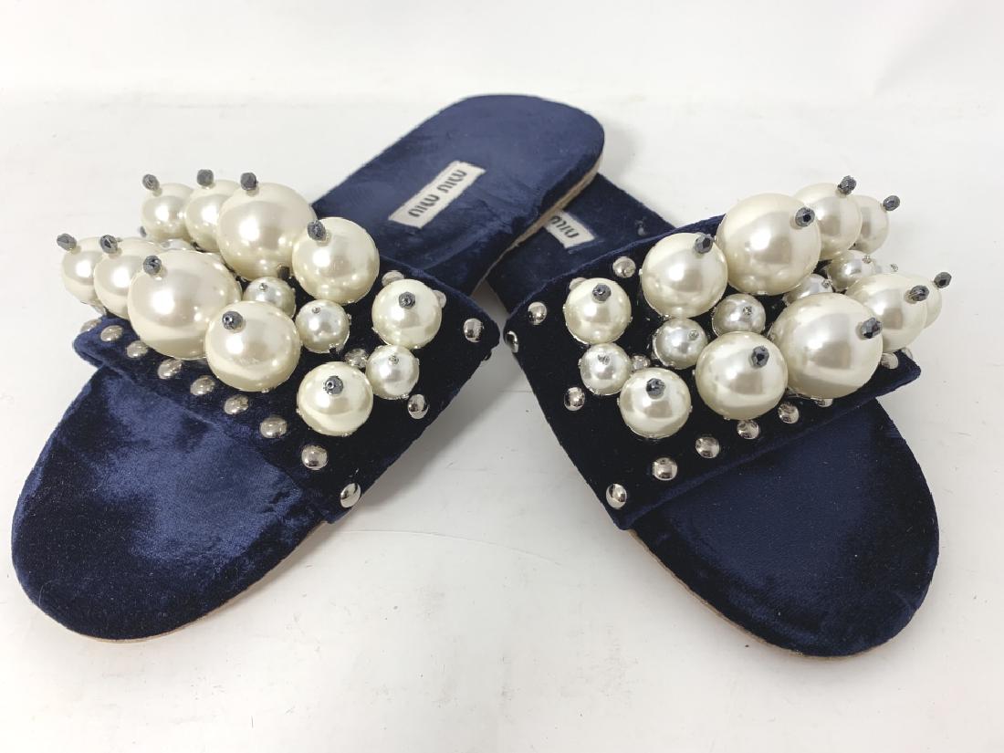 MIU MIU NAVY VELVET FAUX PEARL SLIDES SIZE 35: Miu Miu’s coveted embellished slide is reinvented for the new season in sophisticated Navy. They’re crafted in Italy with a wide toe strap, which is embellished with faux-pearl and gunmetal beads,