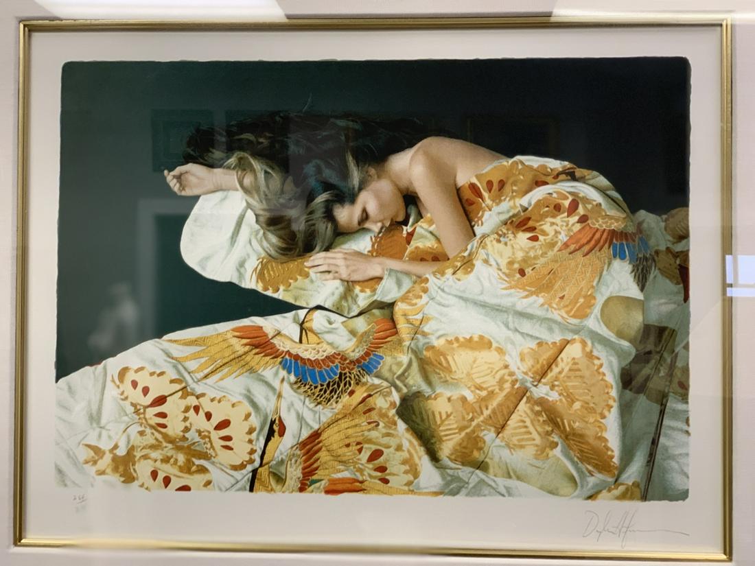 DOUGLAS HOFFMAN FRAMED LITHOGRAPH WOMAN QUILT: This limited edition lithograph depicts a sleeping woman nestled under a quilt. The print is numbered 264/275 and signed lower right.Measures 28" H x 43" WVery good condition