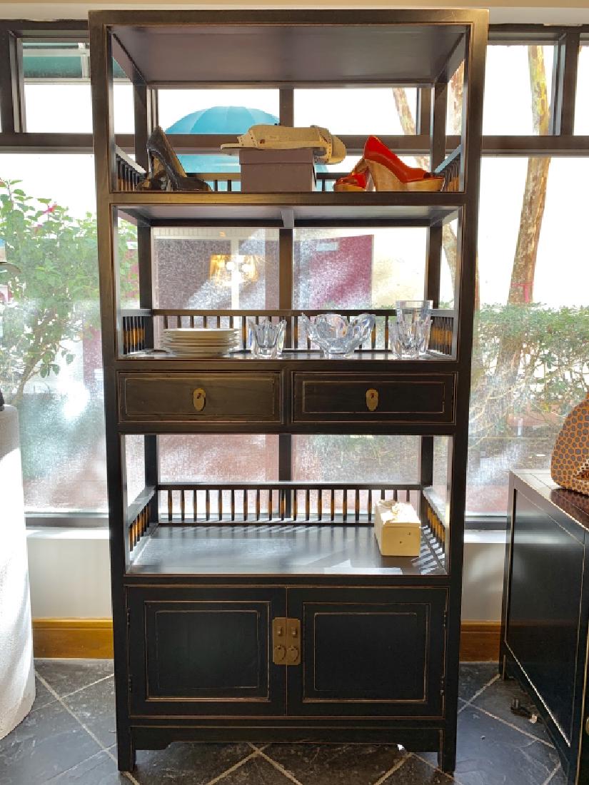 LARGE 3-TIER PACIFIC-INSPIRED BLACK SHELVING UNIT: Large 3-tier Pacific-inspired ebony black shelving unit. The underside of the middle shelf features 2 drawers with drop bail pulls. The bottom shelf doubles as a cabinet with 2 swing doors. Deep ebony