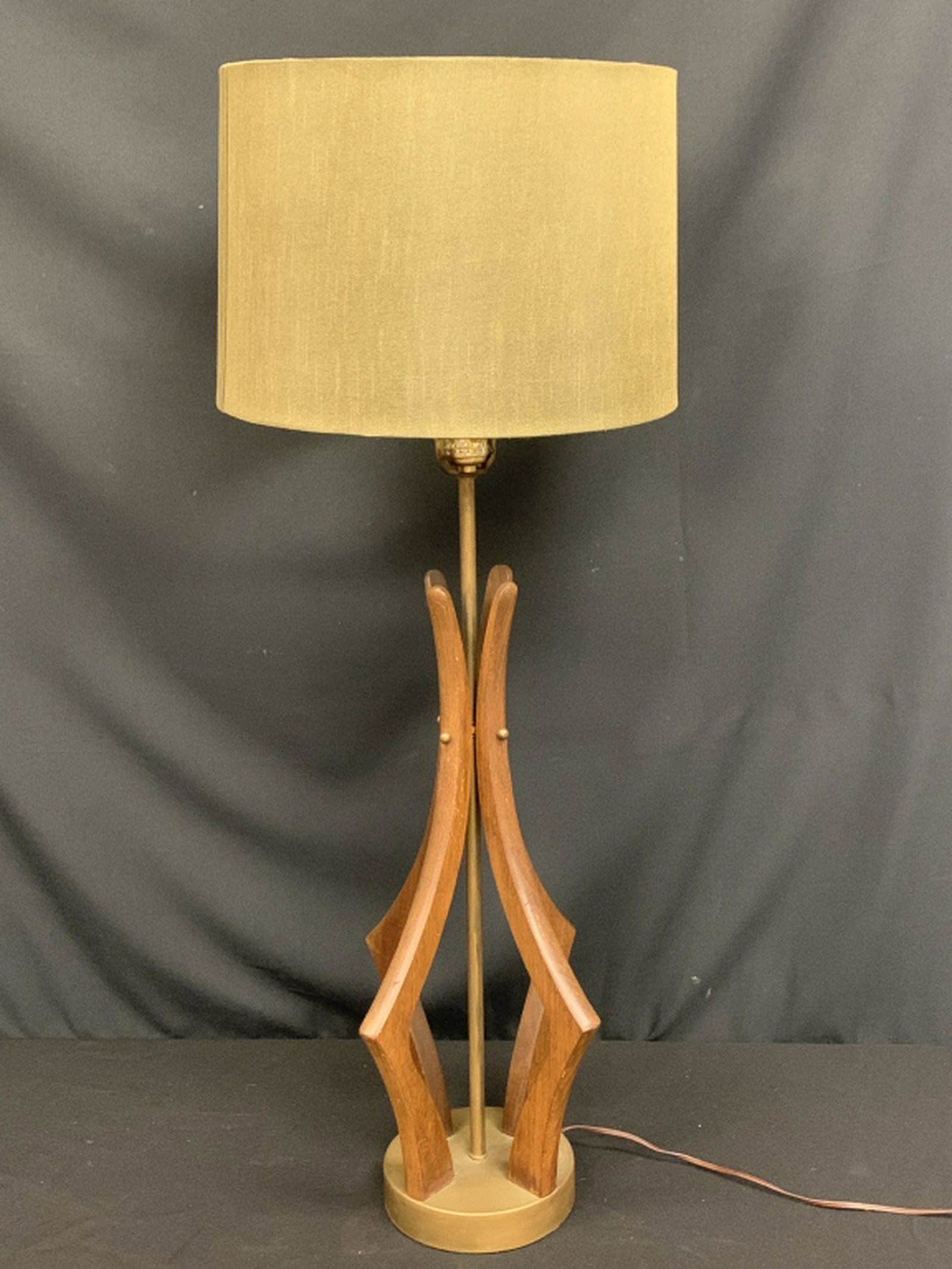 VINTAGE VLADIMIR KAGAN TEAK WOOD MOD LAMP W/SHADE: Stunning lamp by Vladimir Kagan. Constructed of teak wood with stylized arms and brass base. Green mid century lamp shade included. Measurements: 27.5" h x 6.5" Condition: Very good condition but miss