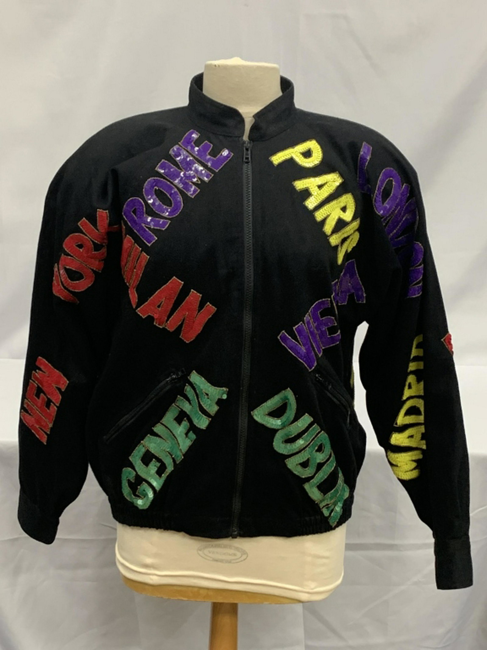 COOL VINTAGE MODI "CAPITALS OF THE WORLD" JACKEt: STUNNING black lined jacket with colorful sequions of major cities throughout the world. Perfect for that world traveler. Padded shoulders and 100% Rayon lined. Made in India. Size 8-10 M