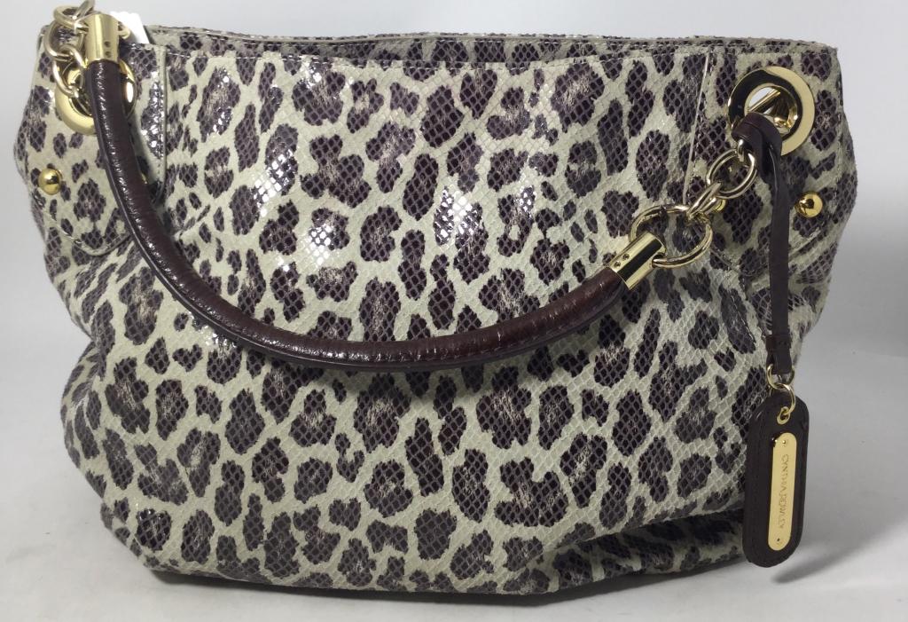 CYNTHIA POWELL LEATHER TOTE IN LEOPARD PRINT: Bag is in like new condition. Measures 11" tall and 14" wide , with 2 brown leather handles. Property of a Palm Beach Socialite. Third party shipping is required