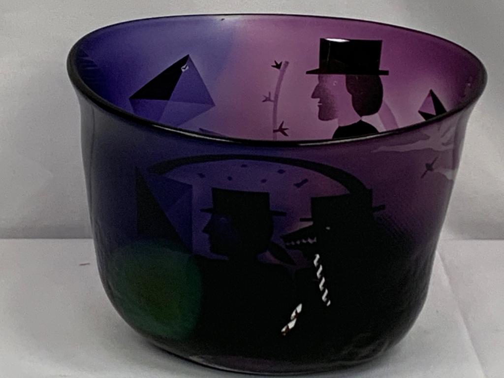 KOSTA BODA B VASEEN PURPLE GOTHIC GLASS BOWL: Signed by Kosta Boda artist B Vaseen. Art glassware by Kosta Boda, signed on the bottom. Measurements 7.5" tall x 10" wide x 8.25" wide. Third party shipping required.