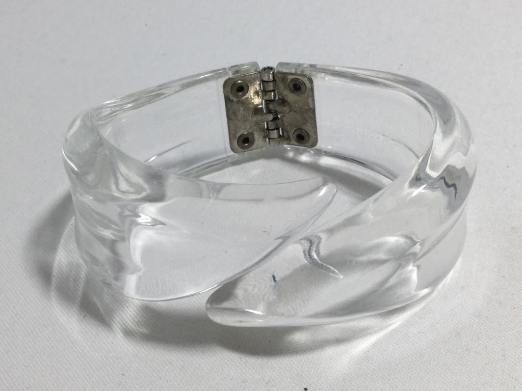 VINTAGE 50'S CARVED CLEAR LUCITE HINGED BRACELET: Beautiful and 1.25" wide at the width, hinges to fit up to a 7.5" wrist nicely. Excellent condition. Vintage. Third party shipping required.
