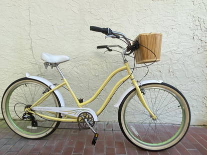 WOMEN'S PHAT CYCLES 6 SPEED BEACH CRUISER W/BASKET: WOMEN'S Phat Cycles low bar cruiser bicycle. Fenders, basket and wide handle bars.6 speed with hand brakesYellow frame with green rims and whitewall tires, just a cool cruiser.