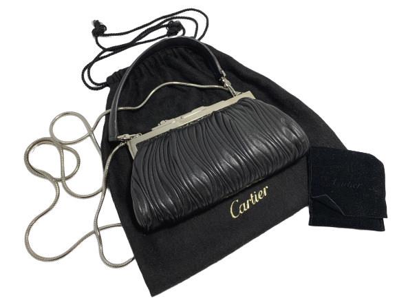 CARTIER BLACK LEATHER ELEGANT SMALL EVE PURSE: Cartier delicate small evening bag/purse. Textured black leather with silvertone frame and leather carry strap and alternate snake chain strap included. Comes with dustbag. 7" wide4" tall1.5" deep