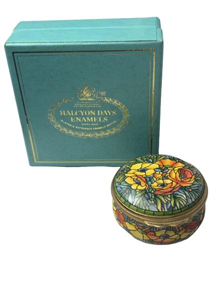 TIFFANY & CO. HALCYON DAYS ENAMEL PILL BOX: This beautiful vintage enamel box has the TIFFANY & CO. design of stained glass of a floral arrangment. Made in England by the Halcyon Days company of Bilston, England. The oval Halcyon Days Enamels m