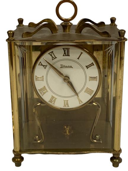 VINTAGE DIANA FANCY METAL MANTEL LIBRARY CLOCK: Darker brass mantel clock by Diana. Working condition. 3.5" X 4.5" X 6" in size. Third party shipping required.