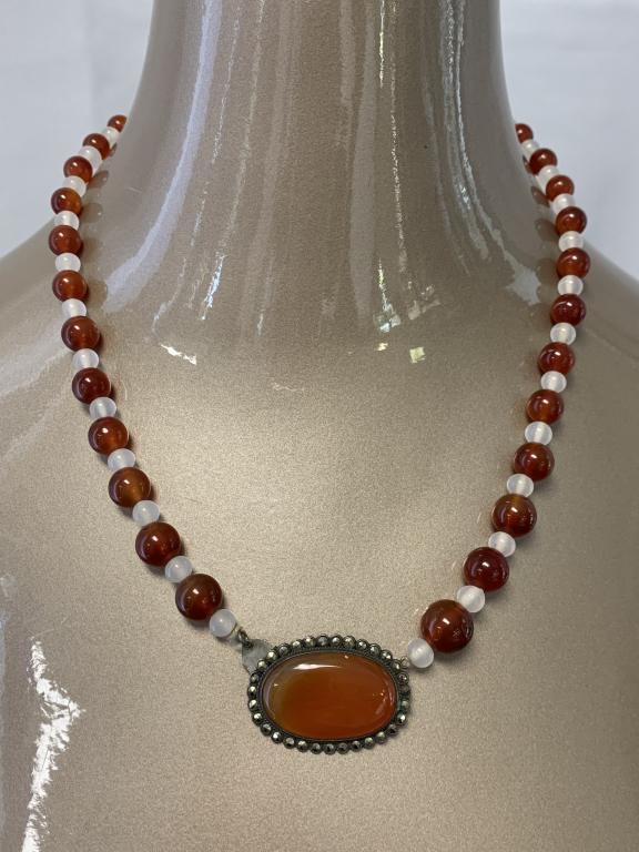 VTG CARNELIAN MARCASITE STERLING SILVER NECKLACE: VTG CARNELIAN MARCASITE STERLING SILVER NECKLACE - 1.5" Oval carnelian framed in marcasite center pendant - Clasp attached to center pendant - Carnelian beading with white glass beads between - 20" to