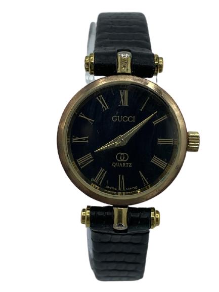 VINTAGE GUCCI BLACK GOLD PETITE WATCH: VINTAGE GUCCI BLACK GOLD PETITE WATCH -FACE IN GOOD CONDITION-LEATHER BAND WORN CONSIDERABLY, SEE IMAGES-WORKING CONDITION UNKNOWN-FACE DIAMETER .75" STRAP LENGTH 7.75"-TK111720